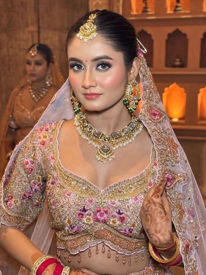 A direct, confident look. The makeup is minimal but impactful, focusing on flawless skin and bright, open eyes.