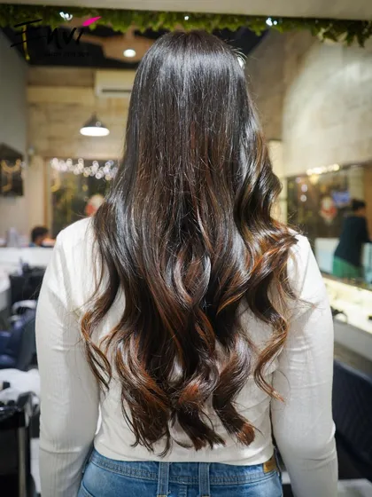Soft waves and face-framing layers. This style is perfect for adding movement and a touch of glamour to long hair.