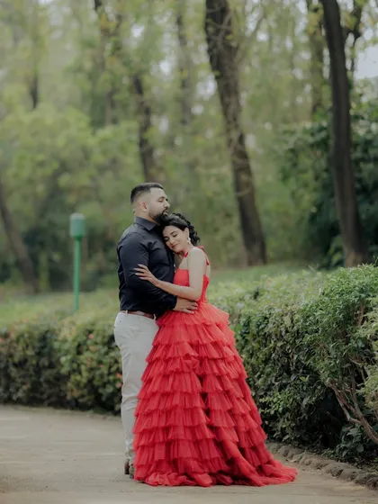 A tender moment of embrace between the couple in a beautiful Pune garden. The composition draws the eye to their connection, making it a perfect example of a romantic and cinematic engagement photo.