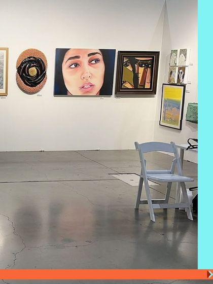 A view of our booth from a past fair, showcasing a mix of portraiture and abstract works.