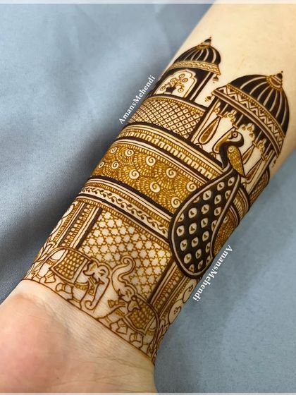 A minimal bridal design with a focus on traditional motifs. The arm features a procession of elephants and peacocks, creating a simple yet elegant look.