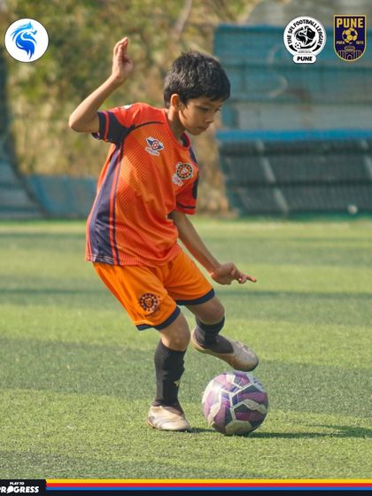 A moment of focus. A young player in Pune prepares to make his next move with the ball at his feet.