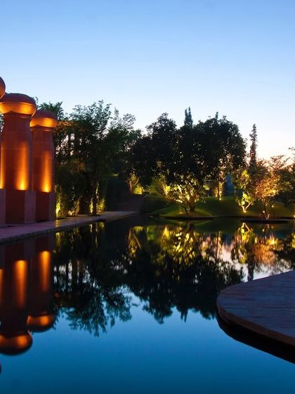 The resort by night is a sight to behold. The architectural pillars are lit to create dramatic reflections in the water, offering a beautiful view during an evening walk or dinner.