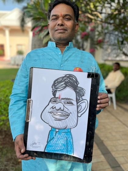 A guest in a bright blue kurta, with a caricature that matches his outfit.