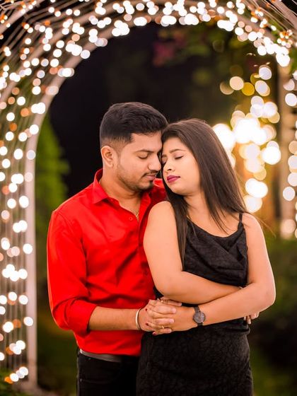 A close, romantic embrace within the light tunnel, where the warm lights create an intimate and cozy atmosphere.