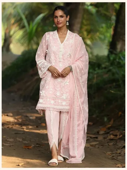 A soft pink kurta set with dhoti pants for a modern twist. The delicate embroidery and comfortable fit make it a stylish and practical outfit.