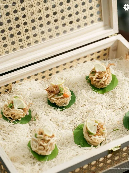 An artful presentation of noodle nests in a bespoke wooden box. This is how we bring innovation and surprise to our home catering menus.