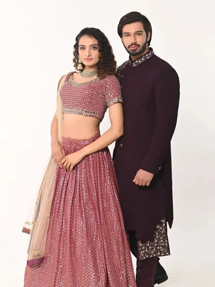 A full-length view of the coordinated couple's outfits, showing how well the colors and styles complement each other.