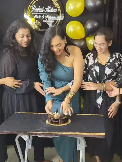 It's not just about learning, it's about celebrating the journey together. Cutting the cake with my students to mark the successful completion of their professional makeup course.