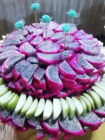 An example of my artistic fruit displays. Here, vibrant pink dragon fruit and green apple slices are meticulously arranged to create a stunning and refreshing centerpiece for the buffet.
