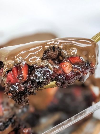 A spoonful of our Boozy Nutella Strawberry cake tub. You get all the decadent layers of rum-soaked sponge, compote, and Nutella in a convenient single serving.
