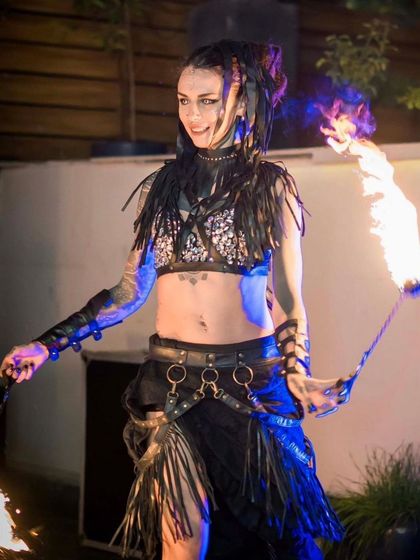An edgy, punk-inspired look for a high-energy fire poi performance. We customize our costumes and styles to match the energy of the event, from mystical fantasies to modern, aggressive themes.
