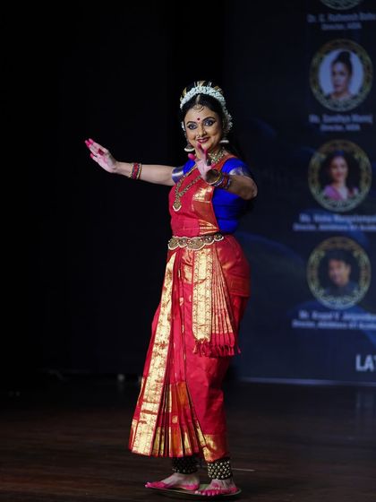 A full-body shot capturing the graceful posture and vibrant costume of the Kuchipudi artist during her performance at our Antaranga festival.