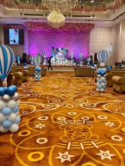 A wide shot of the banquet hall, showing the Hot Air Balloon-themed pillars lining the main walkway, creating a beautiful and immersive effect.