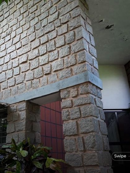 A detail of the stonework at the Rehmat Tarikere Residence, showing the craftsmanship and the timeless quality of the natural material.