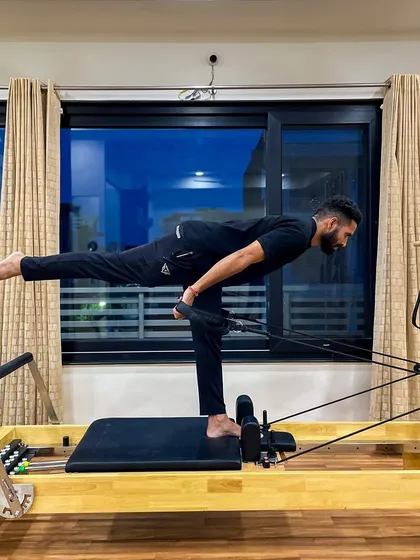 Pilates is for men too. This single-leg deadlift variation on the reformer builds balance, hamstring strength, and core stability.