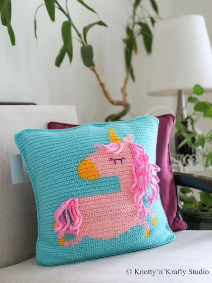 Add a touch of magic to a child's room with my Curly Tails Unicorn Cushion. This soft, huggable pillow features a sweet sleeping unicorn with a bright pink curly mane, making it a dreamy accent for any little one's bed or chair.