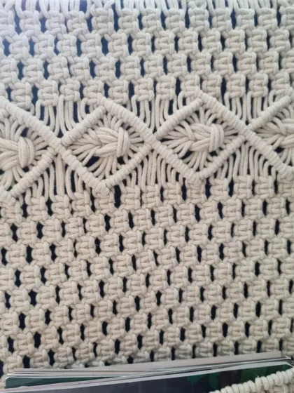 A top-down view of the wall pocket, highlighting the beautiful diamond-patterned knots at the top. Every part of the piece is designed with care.