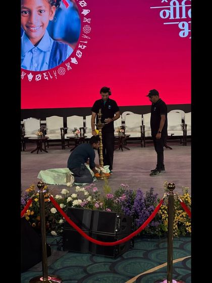 Our team making final adjustments to the ceremonial lamp setup at the Akhil Bhartiya Shiksha Sangam. No detail is too small when it comes to executing a formal event with precision.
