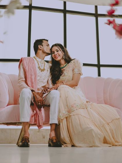 Another shot on the pink sofa, this time with a tender forehead kiss.