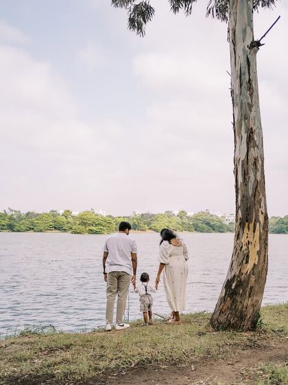 A family by the lake, a quiet and scenic moment. The landscape provides a beautiful, peaceful backdrop.