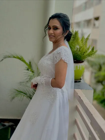 I believe in timeless elegance for my Christian brides. For this look, I focused on soft, romantic makeup with a dewy finish and an elegant updo to perfectly complement her white gown and veil. The result is a graceful and angelic bridal style.