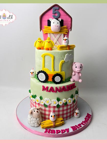 Old MacDonald had a farm, and it was delicious! This three-tiered farm-themed cake for a 5th birthday is full of cute animals, including a sheep, pig, and chicks.