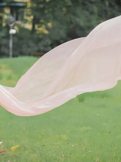 A classic portrait featuring one of my popular flying trail gowns. The soft pink fabric and the outdoor setting create a dreamy, ethereal look that celebrates your journey to motherhood.