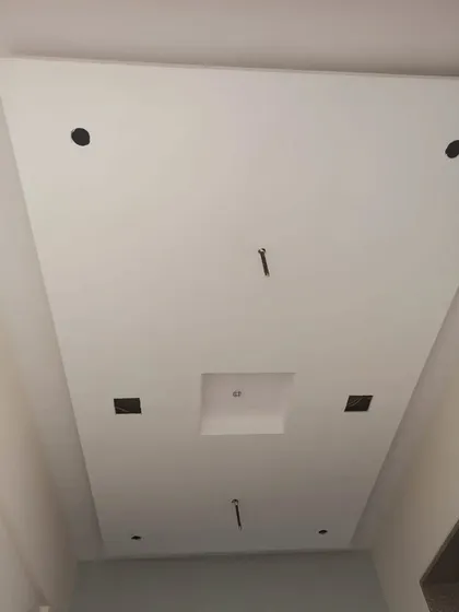 A very simple and clean false ceiling, perfect for a minimalist look. The cutouts are for spotlights and other fixtures.