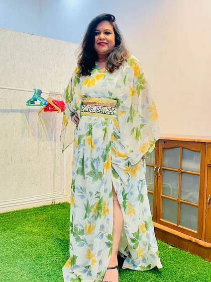 This breezy and stylish floral kaftan dress was made by repurposing a client's saree. The addition of an embellished belt gives it a defined silhouette and a modern touch.