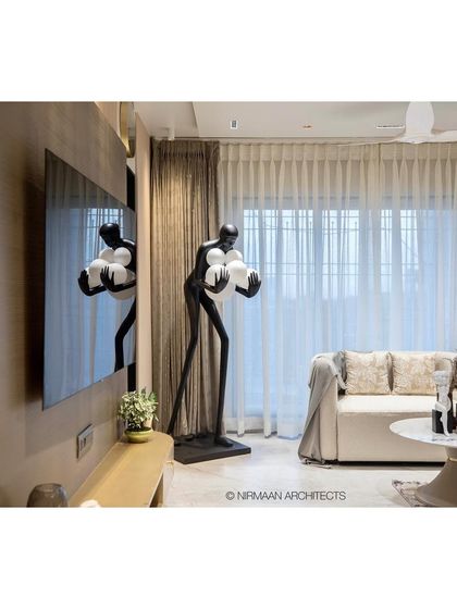 A unique sculptural floor lamp adds an element of surprise and artistry to the living room of the Duplex Project. We often use statement pieces like this to give a room a distinct personality.