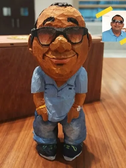 Turning a person's photo into a 3D wooden caricature is my specialty. This piece highlights how I translate a 2D image into a tangible figurine, complete with the subject's style, expression, and even their accessories.