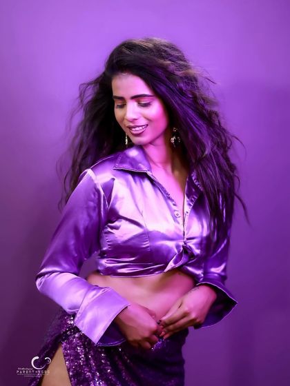 A joyful and candid moment. Her smile and the soft movement in her hair create a warm and approachable portrait.