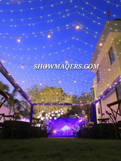 Our capabilities extend to creating beautiful outdoor settings for corporate celebrations and retreats. This evening setup for a retirement party features a canopy of fairy lights and elegant seating, transforming a simple lawn into a magical venue.