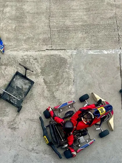 An overhead view of the karts in the pit area.