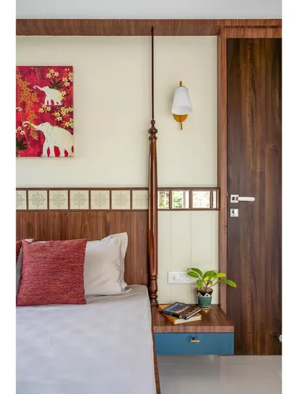 Details make the design. This shot focuses on the intricate post of the four-poster bed and the traditional tile-like border on the headboard.
