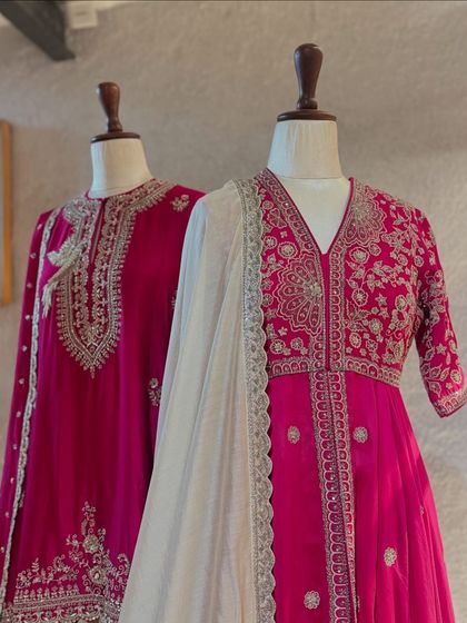 Two magnificent fuchsia ensembles by Jayanti Reddy, one a classic kurta and the other a peplum-style top, both showcasing her mastery of traditional embroidery.