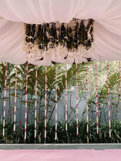 Another angle of the mandap area, with its draped ceiling and hanging floral installations. The design creates a cozy and sacred space for the wedding rituals.