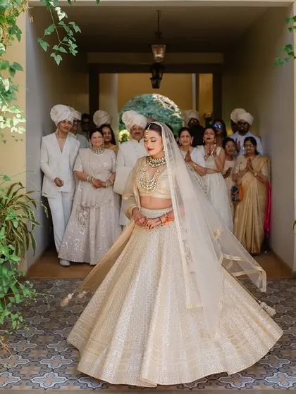 The bride's stunning twirl as she reveals her wedding look to her family. A moment of pure happiness and excitement at Sula Vineyards.