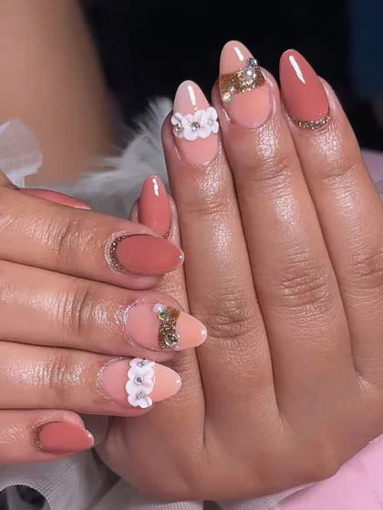 A beautiful peach-toned set with a mix of matte and glossy finishes, adorned with 3D white flowers and gold crystal accents.