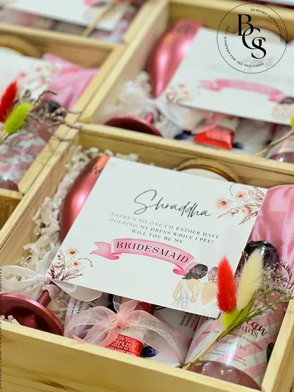 Asking your best friends to be your bridesmaids is a once-in-a-lifetime moment. This personalized proposal box is filled with everything needed to make them feel cherished, including a custom-named wine glass, sparkling rosé, and other pampering essentials, all nestled in a keepsake wooden crate with their name on it.
