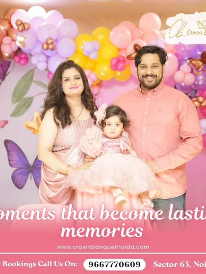 A picture-perfect family moment at a butterfly-themed birthday. The soft pink and purple balloon decor creates a beautiful and gentle atmosphere for celebrating your little one.