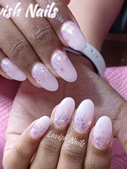Soft pink almond nails with a chunky iridescent glitter fade for a magical, light-catching effect.