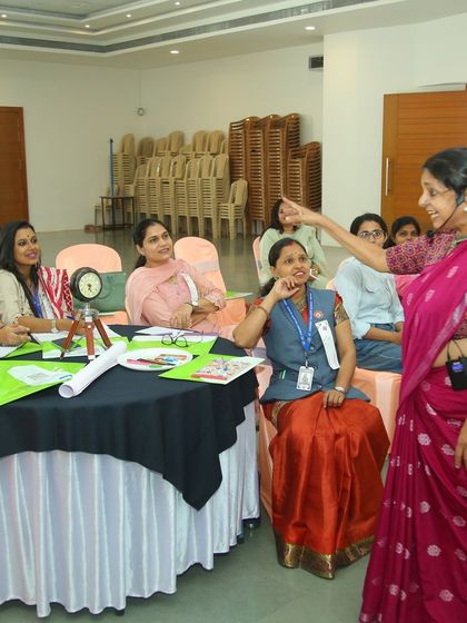 Interacting closely with a table of teachers during the 'Seekho Learning Series' in Indore. Personal connection makes the learning experience richer.