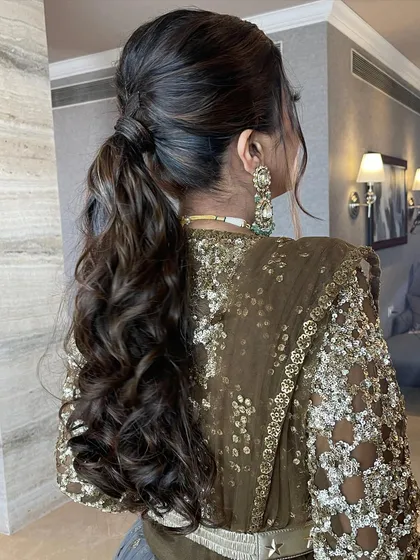 A beautiful shot of the groom's sister with her stylish messy ponytail.