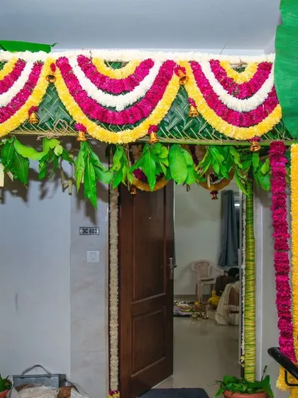 A traditional entrance chapra for a Gruhapravesam or housewarming ceremony. I use real banana trunks, mango leaves, and garlands of marigold and chrysanthemums to create an authentic and auspicious welcome.