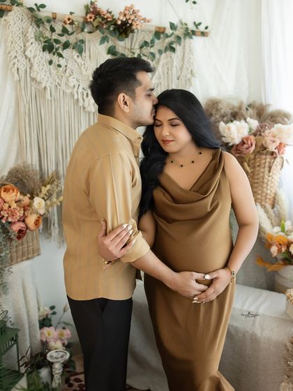 A romantic and intimate portrait of a couple. The husband's gentle kiss on his wife's forehead is a timeless expression of love and care.