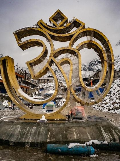 The Om symbol at Kedarnath, set against the snow-covered landscape, is a powerful sight. It represents the primordial sound of the universe, a sound you feel in the deep silence of the mountains. It is a focal point for meditation and reflection amidst the raw beauty of the Himalayas.