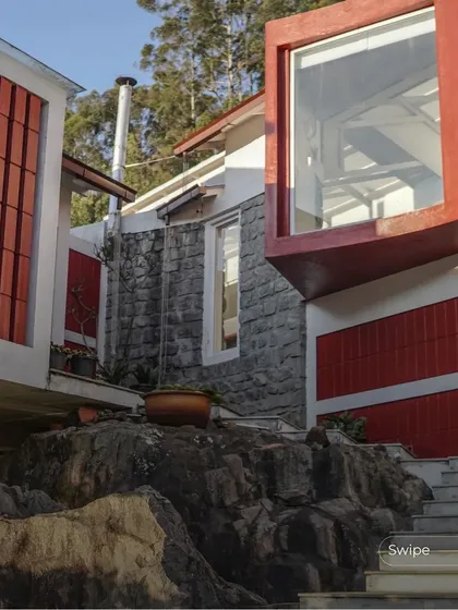 A close-up of the projecting bay window and the original rock formation it was built around, illustrating our philosophy of working with the land.