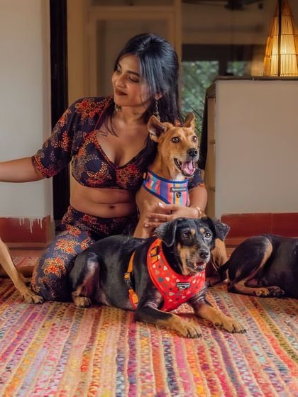 A vibrant portrait of a woman with her four indie dogs. This image is a beautiful celebration of her love for her rescued pack.